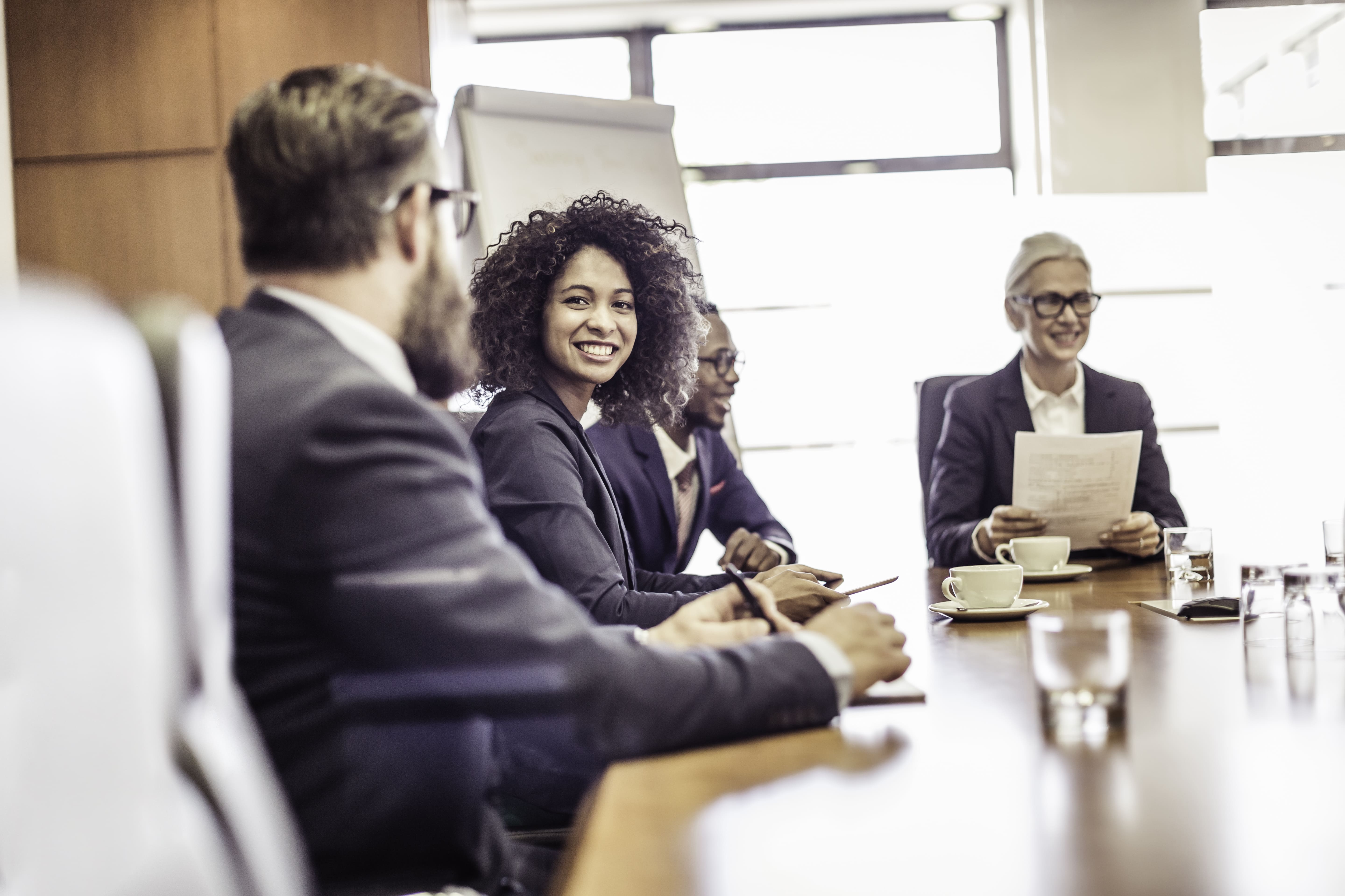 businesswomen-and-men-talking-at-conference-table-2023-11-27-05-34-35-utc (1)